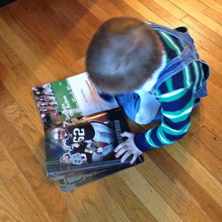 Biggest Little Fan. Hudson loves a good football game, the Pats in particular. Then we noticed him with the old 2010 New England Patriots yearbook.