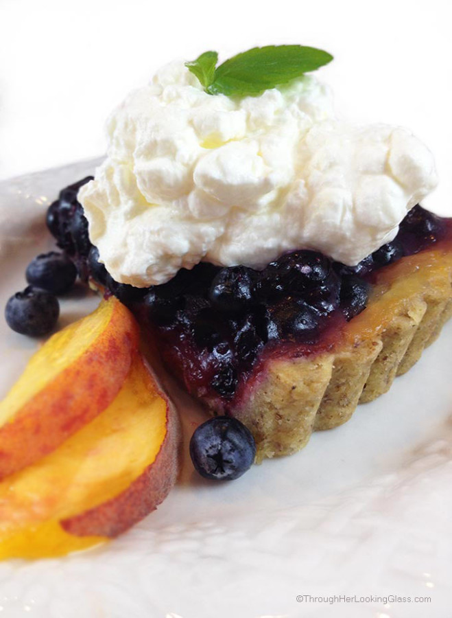 Blueberry Peach Tart. Buttery pecan tart crust with luscious layers of peaches and blueberries. Garnish with fresh peaches and whipped cream.