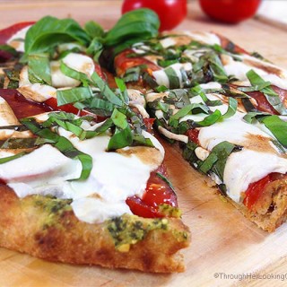 Caprese Pesto Flatbread. Fresh basil pesto, tomatoes, fresh mozzarella and drizzle of balsamic vinegar combine for a fresh & delicious flatbread pizza.