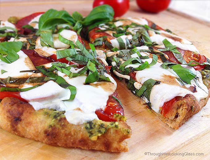 Caprese Pesto Flatbread. Fresh basil pesto, tomatoes, fresh mozzarella and drizzle of balsamic vinegar combine for a fresh & delicious flatbread pizza.