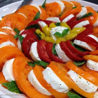 Caprese Salad Garden Tomatoes: spectacular & easy to make. This platter features Orange Wellington, Opalka, and Yellow Pear tomatoes. Sweet and delicious.