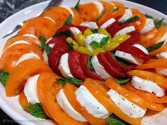 Caprese Salad Garden Tomatoes: spectacular & easy to make. This platter features Orange Wellington, Opalka, and Yellow Pear tomatoes. Sweet and delicious.
