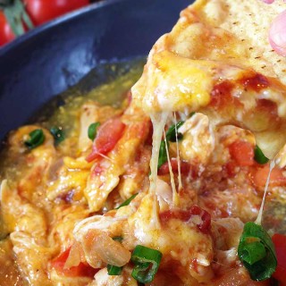 Chipotle Queso Fundido Skillet. Melty, stretchy, molten cheese. Shredded chicken and salsa, tomatillo & chipotle sauces. Smoky, spicy and sweet!