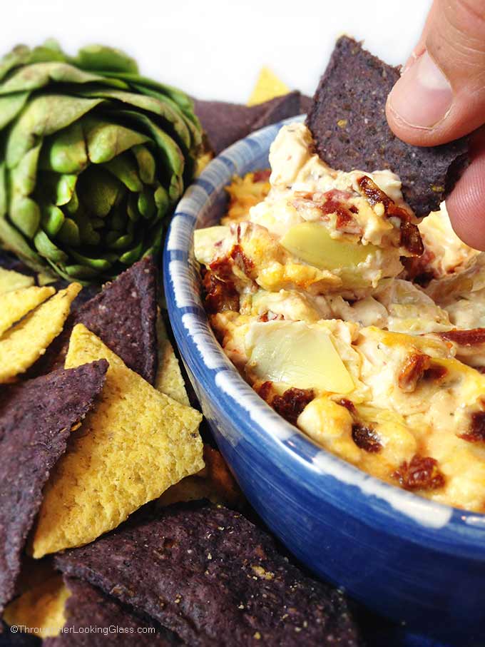 Hot Feta Artichoke & Sun-Dried Tomato Dip. Goes fast! Sun-dried tomatoes, artichokes, feta and garlic combine for a creamy and addictive appetizer dip. Serve hot with bagel chips, tortilla chips or plain crackers.