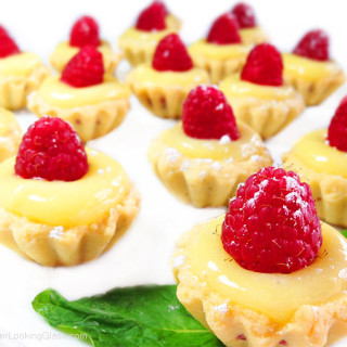 Irresistible Raspberry Lemon Tartlets. Crunchy, light tart shells layered with seedless raspberry jam, lemon curd and fresh raspberries. Need I say more?