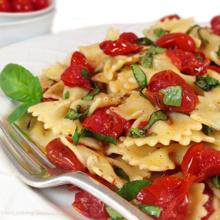 Blistered Tomato Basil Pasta Salad w/Truffle Oil. Ideal summer side dish. Garlic mingles w/basil, blistered tomatoes & farfalle pasta. Irresistible!