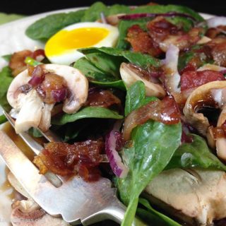 Maple Warm Bacon Dressing Spinach Salad: sweet maple syrup combines with warm bacon dressing atop spinach greens. Eating your greens never tasted so good!