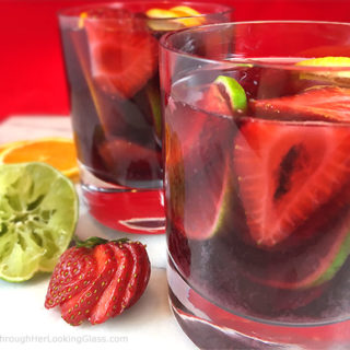 This lip-smacking Strawberry Sangria Recipe is a crowd-pleaser! Fresh fruit, merlot and a few other secret ingredients make the best sangria "brew" ever!