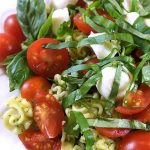 This Caprese Pasta Salad Recipe: perfect side incorporating your garden basil! Fresh basil pesto, pasta, sun-ripened tomatoes and fresh mozzarella. Delish!