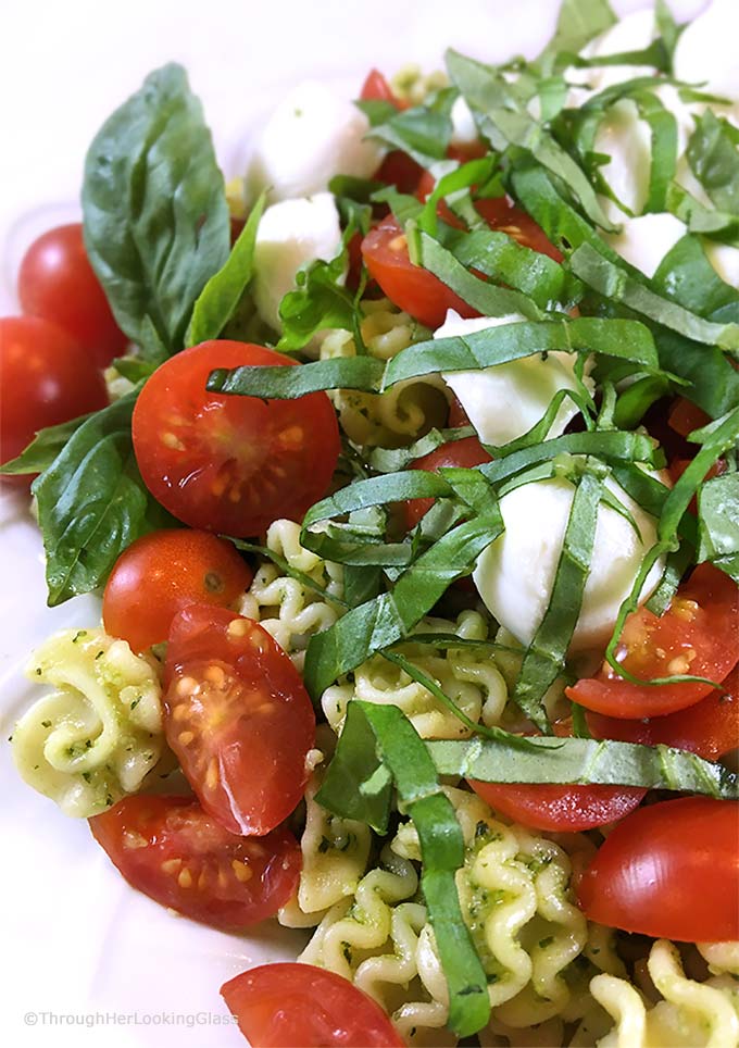 This Caprese Pasta Salad Recipe: perfect side incorporating your garden basil! Fresh basil pesto, pasta, sun-ripened tomatoes and fresh mozzarella. Delish!