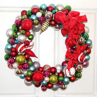 This Willy Wonka Christmas Ball Wreath is a fun and sparkly way to welcome in the Christmas holidays. Easy to make too. Just hot glue Christmas ornaments of various colors, shapes and sizes onto a styrofoam wreath form.