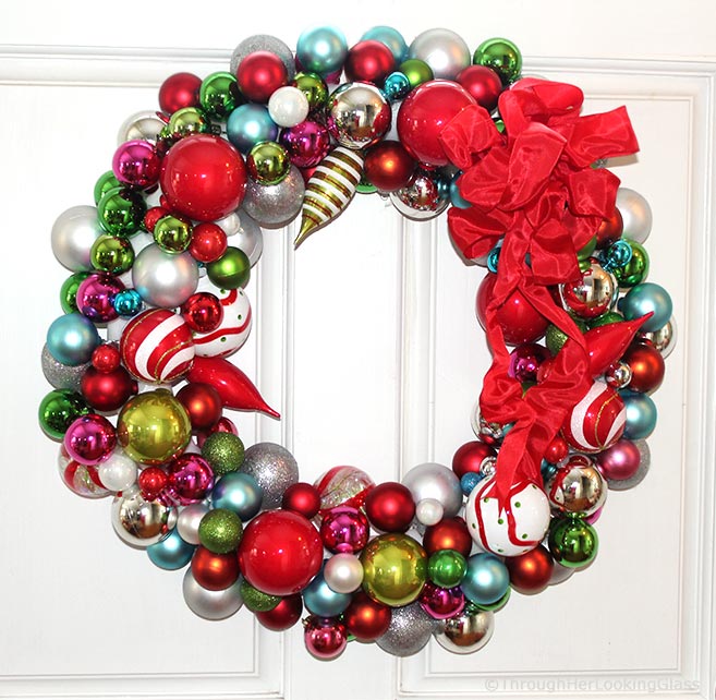 This Willy Wonka Christmas Ball Wreath is a fun and sparkly way to welcome in the Christmas holidays. Easy to make too. Just hot glue Christmas ornaments of various colors, shapes and sizes onto a styrofoam wreath form.