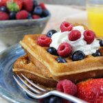 Pair these tender, golden White Wheat Buttermilk Waffles with fresh berries and powdered sugar or butter and maple syrup for a delicious treat.