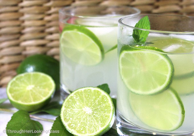 limeade in white glasses with slices of lemon inside