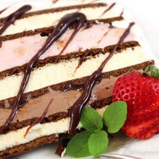 This Easy Neapolitan Ice Cream Sandwich Cake Recipe is fast fast fast to make. And it disappears just as quickly too. Layer ice cream and fudge sauce between ice cream sandwiches and you're good to go! Say goodbye to expensive store bought ice cream cakes this summer.