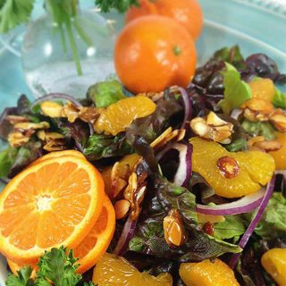 Mandarin Orange Salad: candied almonds combine w/sweet mandarins, red onion & a sweet spicy dressing for a delicious & colorful salad. This disappears fast!