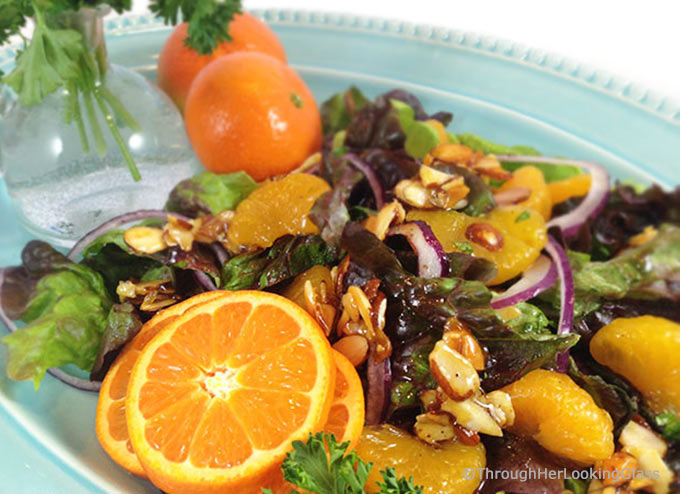 Mandarin Orange Salad: candied almonds combine w/sweet mandarins, red onion & a sweet spicy dressing for a delicious & colorful salad. This disappears fast!