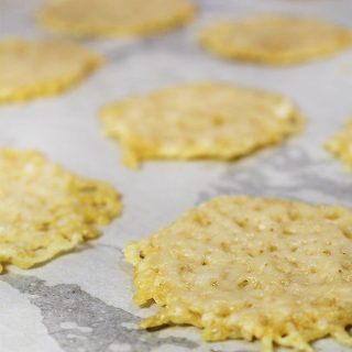 Salty, crispy, low carb and addictive: Easy Gourmet Baked Parmesan Cheese Crisps. You'll love these easy to make oven baked cheese crisps.