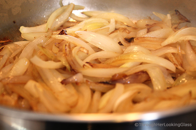 these caramelized onions halfway through the cooking process in a skillet