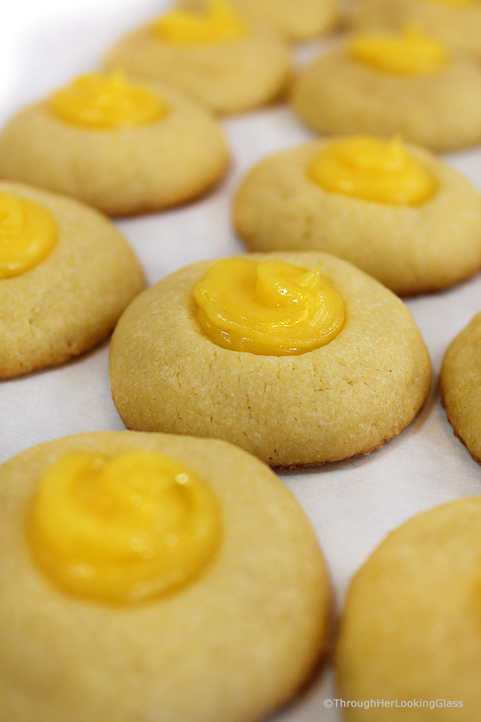 Here's a buttery shortbread Lemon Curd Easy Thumbprint Cookie Recipe for cheerful springtime baking! Buttery shortbread cookies nest dollops of yummy sweet & sour lemon curd. If you love lemon curd like I do, this is the easy cookie for you!