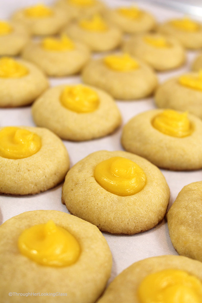 Here's a buttery shortbread Lemon Curd Easy Thumbprint Cookie Recipe for cheerful springtime baking! Buttery shortbread cookies nest dollops of yummy sweet & sour lemon curd. If you love lemon curd like I do, this is the easy cookie for you!