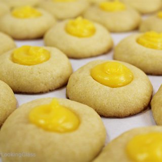 Here's a buttery shortbread Lemon Curd Easy Thumbprint Cookie Recipe for cheerful springtime baking! Buttery shortbread cookies nest dollops of yummy sweet & sour lemon curd. If you love lemon curd like I do, this is the easy cookie for you!