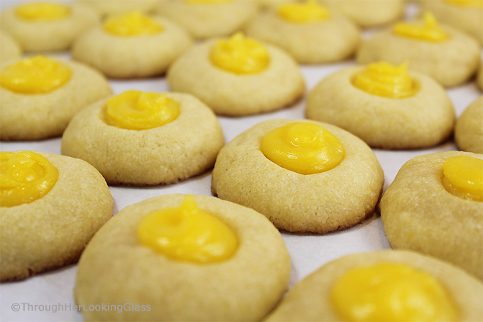 Here's a buttery shortbread Lemon Curd Easy Thumbprint Cookie Recipe for cheerful springtime baking! Buttery shortbread cookies nest dollops of yummy sweet & sour lemon curd. If you love lemon curd like I do, this is the easy cookie for you!