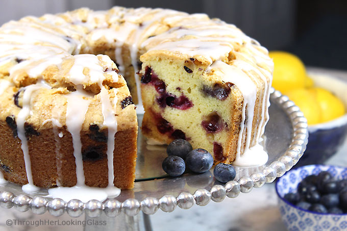 A generous slice of this Glazed Lemon Blueberry Pound Cake is especially scrumptious on the sun porch accompanied by a tall glass of fresh squeezed lemonade. And a sprig of mint. Tender, buttery lemon pound cake is studded with fresh, juicy blueberries for the perfect summer combo.