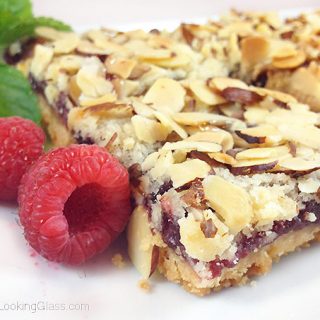 These old-fashioned Peach & Raspberry Shortbread Squares (w/Almonds) are perfect for picnics and lunch boxes this summer. Crunchy and sweet, buttery and packed with peach, almond & raspberry flavor.