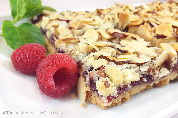 These old-fashioned Peach & Raspberry Shortbread Squares (w/Almonds) are perfect for picnics and lunch boxes this summer. Crunchy and sweet, buttery and packed with peach, almond & raspberry flavor.