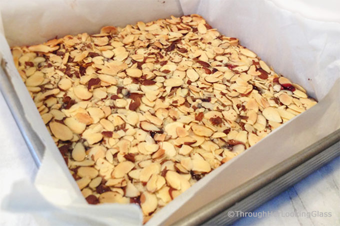 These old-fashioned Peach & Raspberry Shortbread Squares (w/Almonds) are perfect for picnics and lunch boxes this summer. Crunchy and sweet, buttery and packed with peach, almond & raspberry flavor.