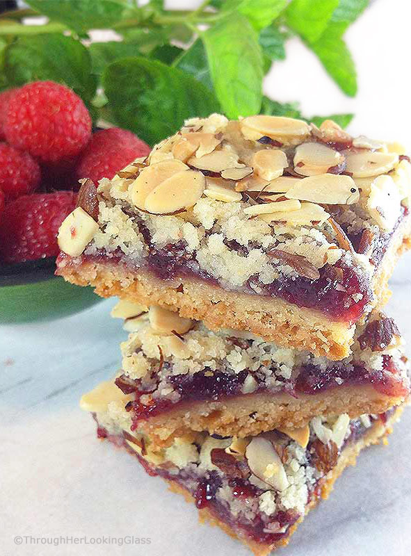 These old-fashioned Peach & Raspberry Shortbread Squares (w/Almonds) are perfect for picnics and lunch boxes this summer. Crunchy and sweet, buttery and packed with peach, almond & raspberry flavor.