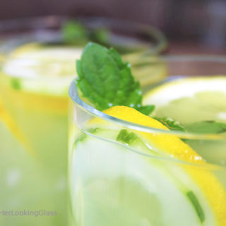 Mint Infused Cucumber Lemonade is a refreshing cold, all natural drink on a hot day. Sweet lemonade combines with fresh cucumber juice and muddled mint and is delicious iced! Refreshing cold sip for a hot summer's day.