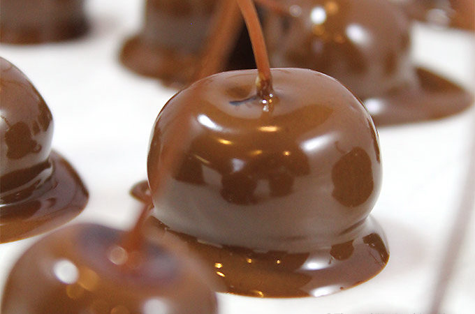 Homemade Chocolate Covered Cherries are a pop of delicious flavors in your mouth! Dunk dye-free, preservative free maraschino cherries in chocolate for an extra special treat at the holidays. Soak cherries in rum, brandy or alcohol first for extra flavor pop!